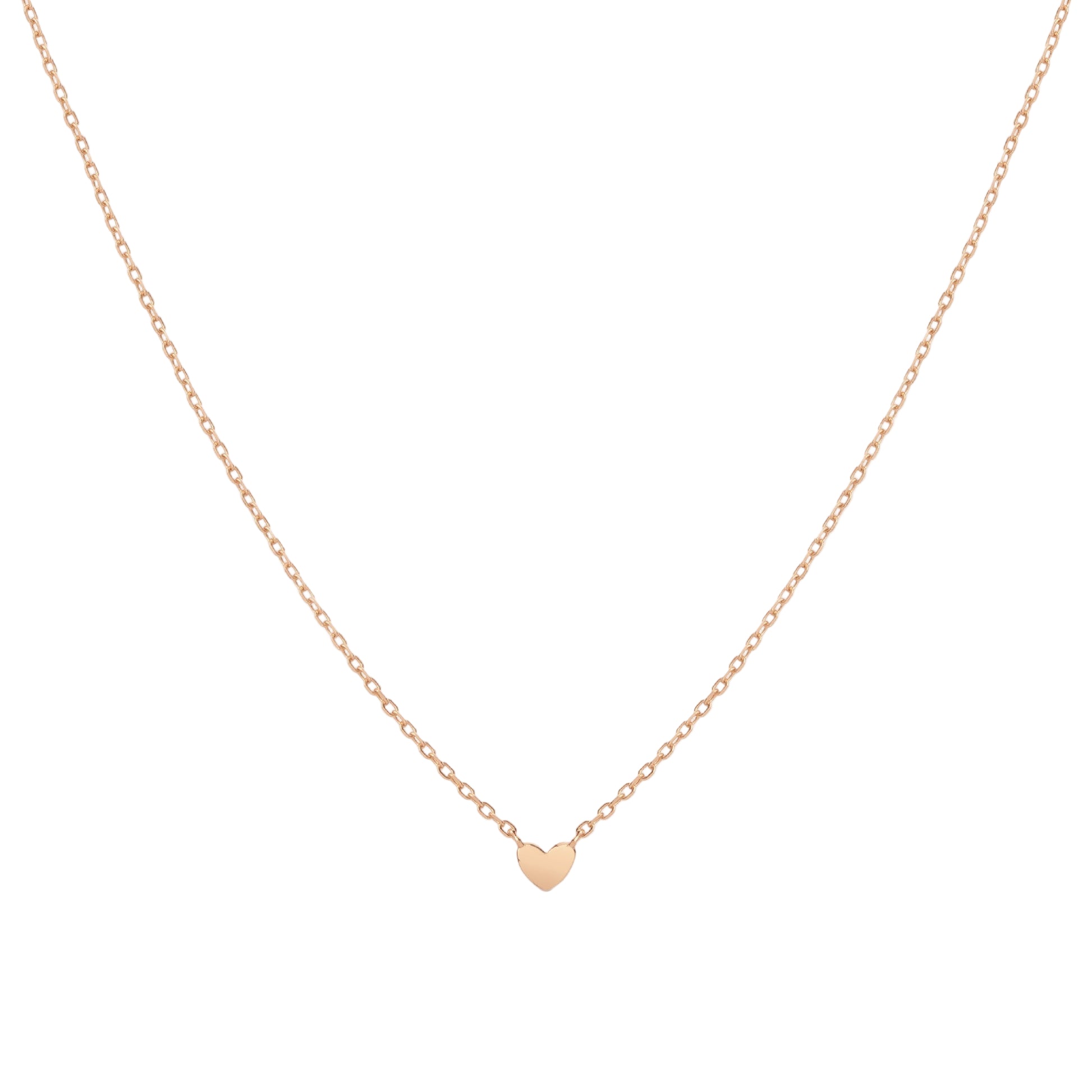gold heart-shaped pendant necklace on a light beige background