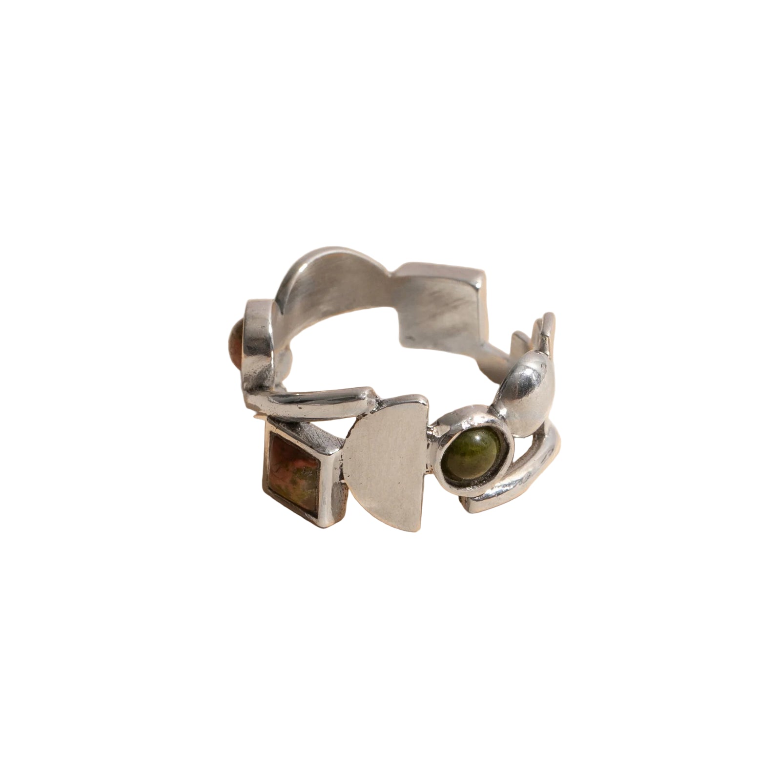 Silver ring with geometric design and green stone on white background