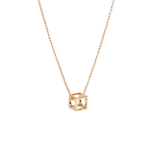 A minimalist geometric cube pendant necklace in gold vermeil on a delicate rolo chain.