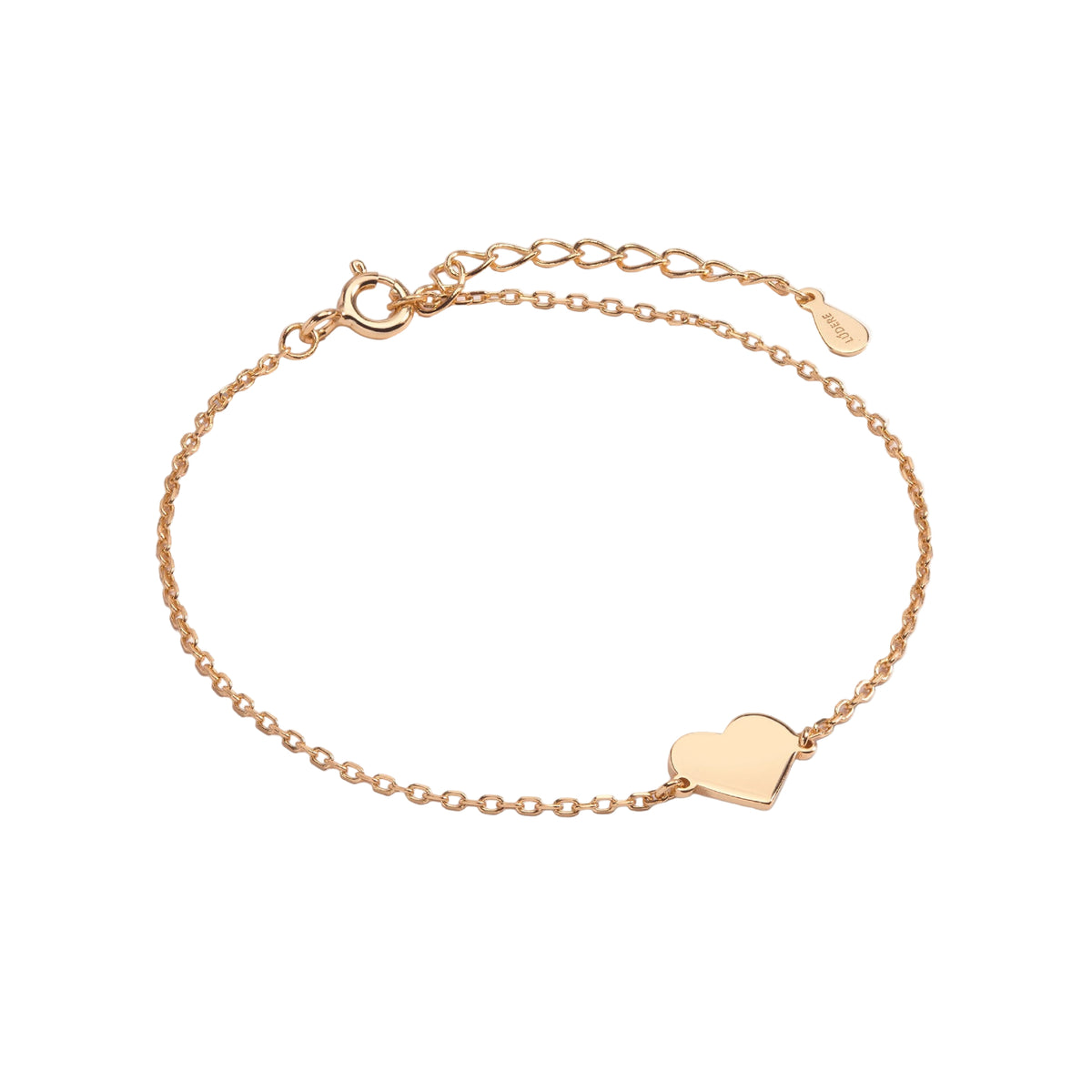Gold bracelet with a heart charm on a light gray background