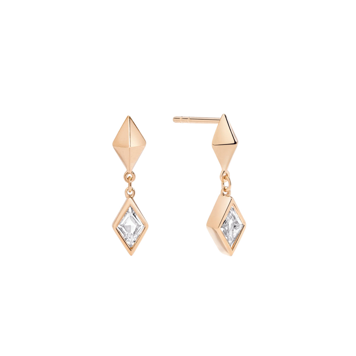 gold earrings with diamond-shaped pendants on a light pink background